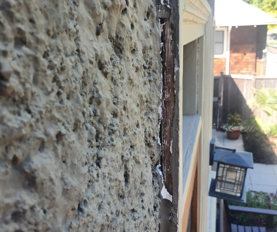 Examining Damage on a Historic Portland Home’s Exterior Stucco and Woodwork