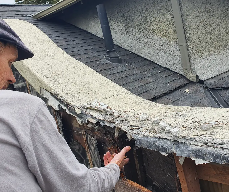 Close-up of damaged stucco and wood on a historic Portland home during restoration