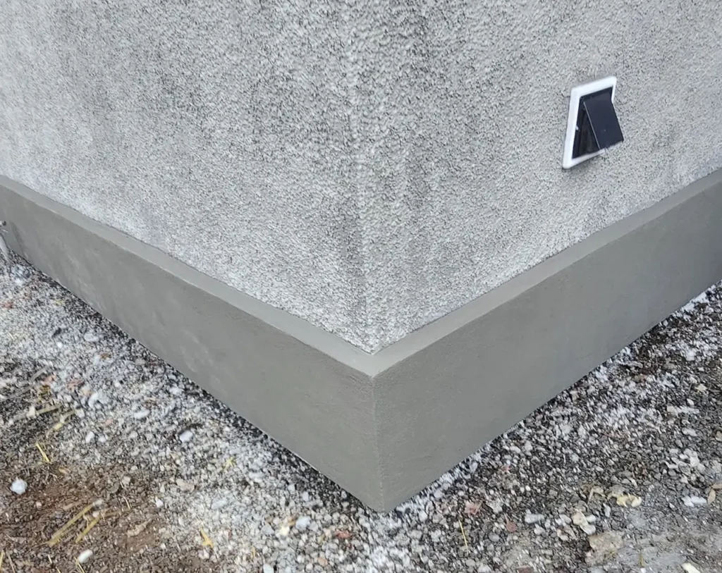 Close-up of matched pebbledash stucco texture during historic home restoration in Portland